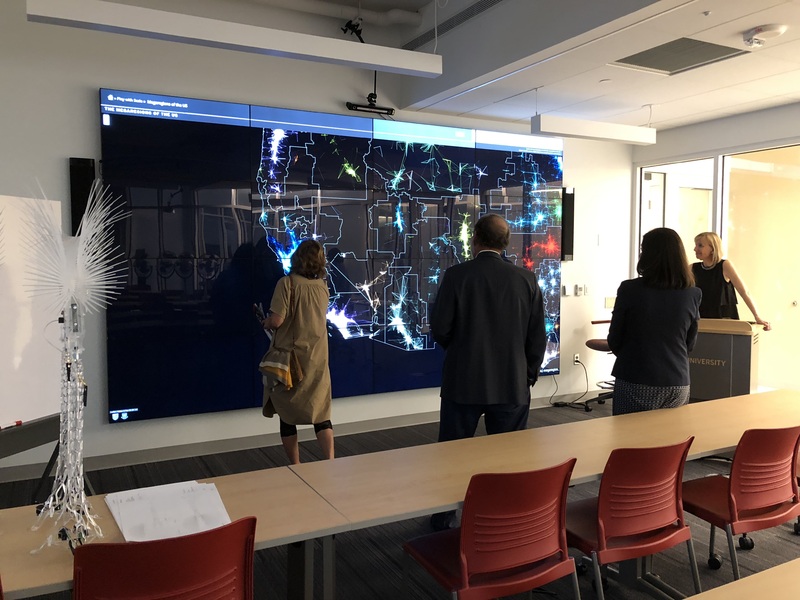 Luddy Hall IQ Wall of globe map with 3 people observing in front.