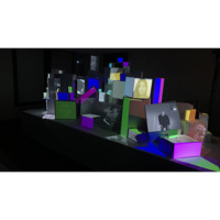 3D multi-colored architectual models on a black rectangular screen in a white square background.